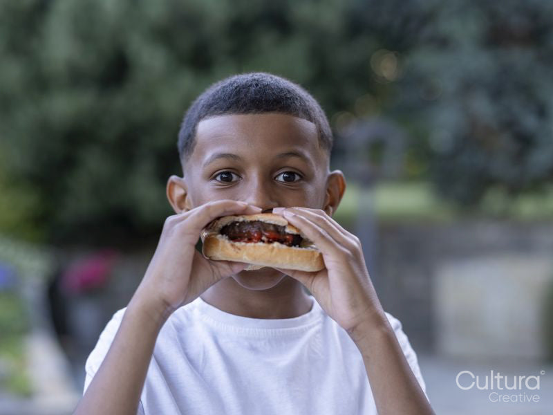 Portrait of boy eating hamburger