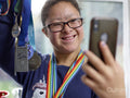 Girl with Down syndrome taking selfie with medals