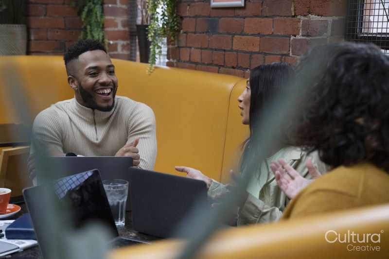 People using laptops in coworking space