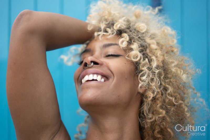 Close-up of smiling woman with curly hair