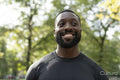 Portrait of smiling man standing in park