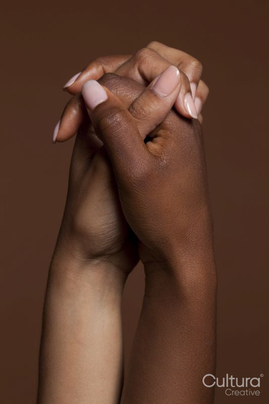 Close-up of women holding hands