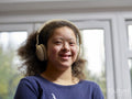 Portrait of smiling girl with Down Syndrome with headphones