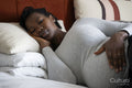 Pregnant woman sleeping on bed