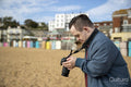 Mid adult man taking pictures on beach