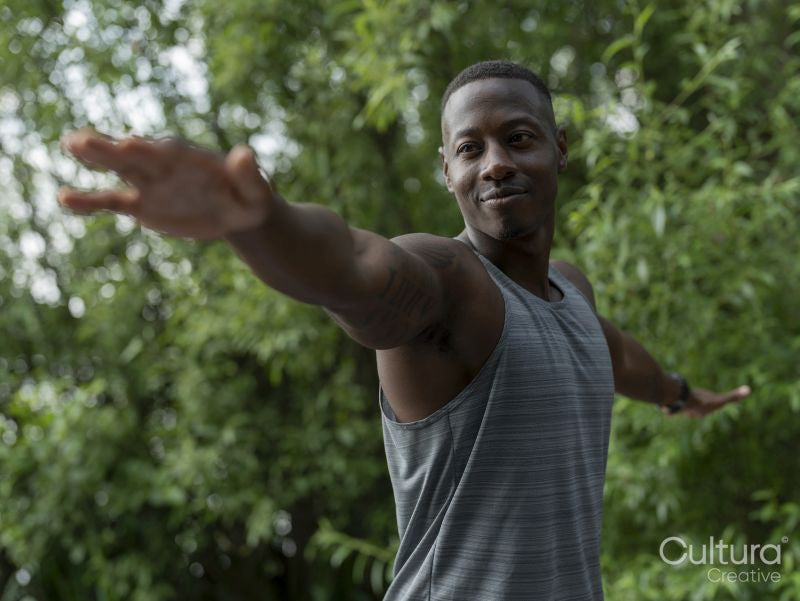 Man practicing yoga in park