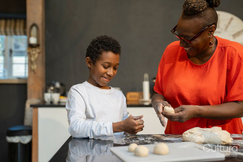 Boy with grandmother preparing dough in kitchen