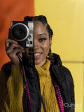 Young woman using vintage camera