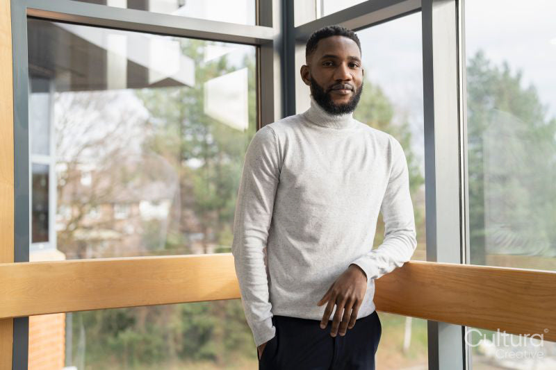 Portrait of young businessman standing in office