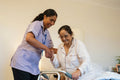 Nurse helping senior lady in her room at nursing home