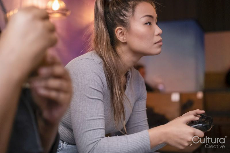 Friends playing in video games at pub