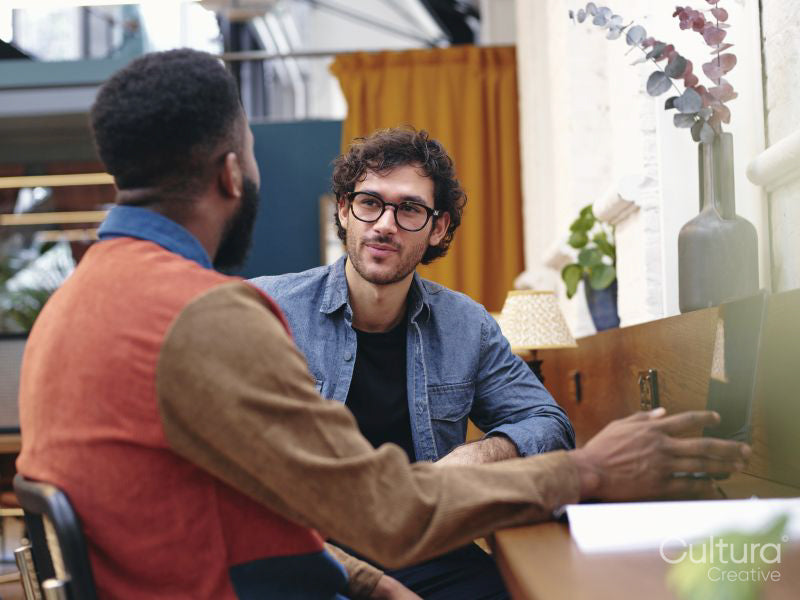 Two businessmen talking in creative studio
