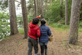 Mother and son walking in forest with basket