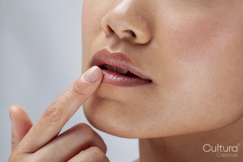 Close-up of woman touching lips