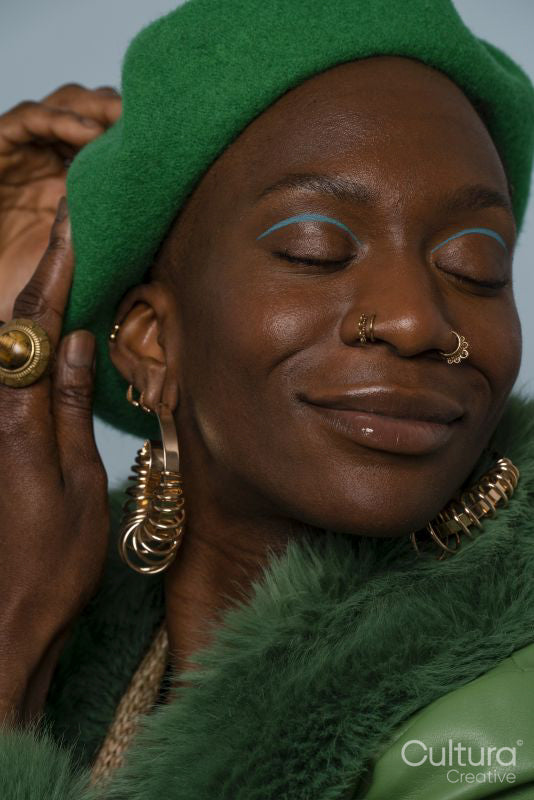 Smiling young woman wearing jewelry and beret