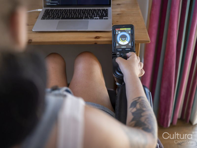 Woman in electric wheelchair using joystick with screen