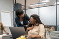 Businesswoman congratulating colleague in office