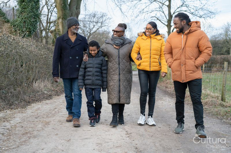 Three generation family walking together in rural area