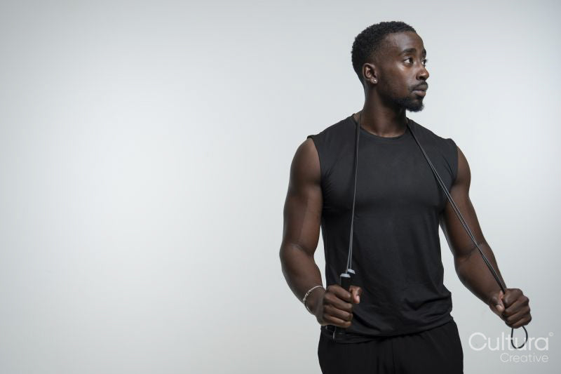 Portrait of man holding jump rope