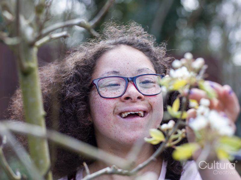 Girl looking at blossoms