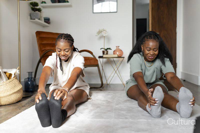 couple stretching on floor at home