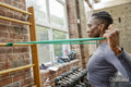 Athletic woman exercising with resistance band at gym