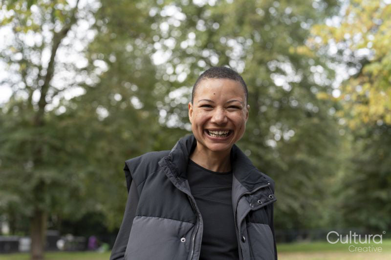 Portrait of smiling woman in sports clothing in park
