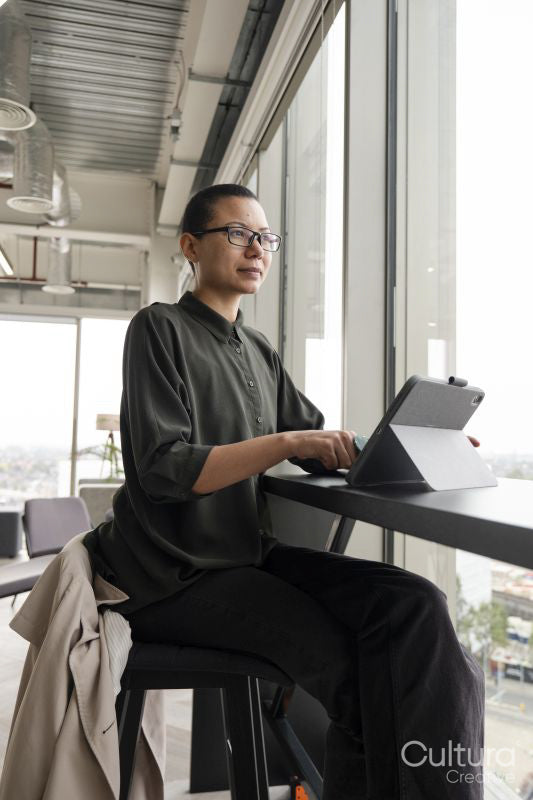 Woman using digital tablet in office