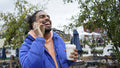 Young man holding coffee and talking on phone