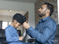 Father wrapping turban around son's head