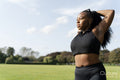 Young woman stretching in park