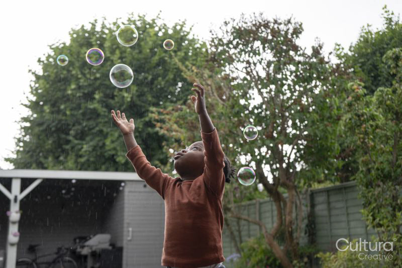 Girl playing with soap bubbles