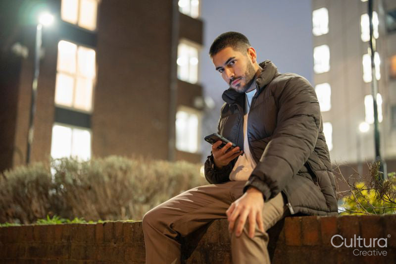 Portrait of young man using smart phone outdoors