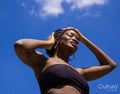 Portrait of young woman under blue sky
