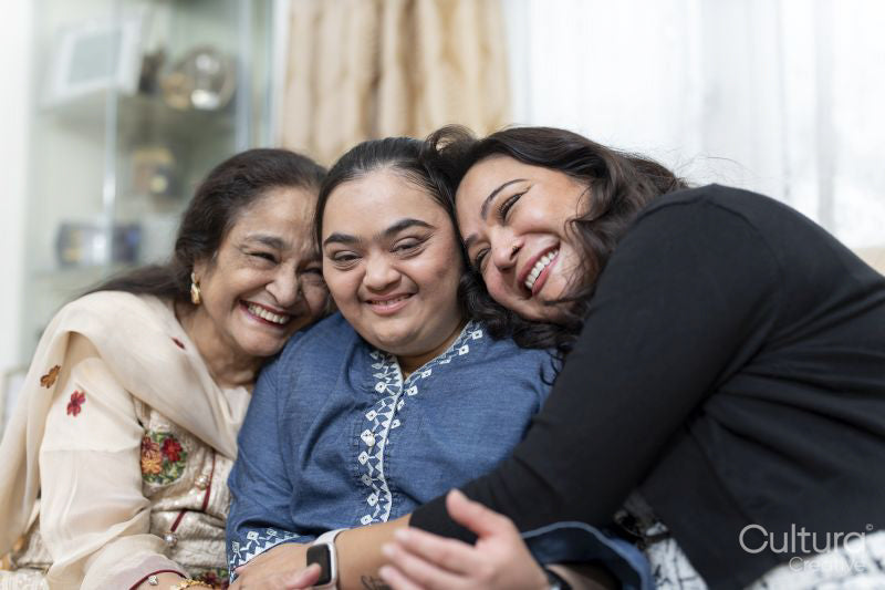 Family portrait with a young woman with down syndrome smiling at home
