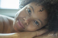 Close-up of woman leaning on edge of bathtub