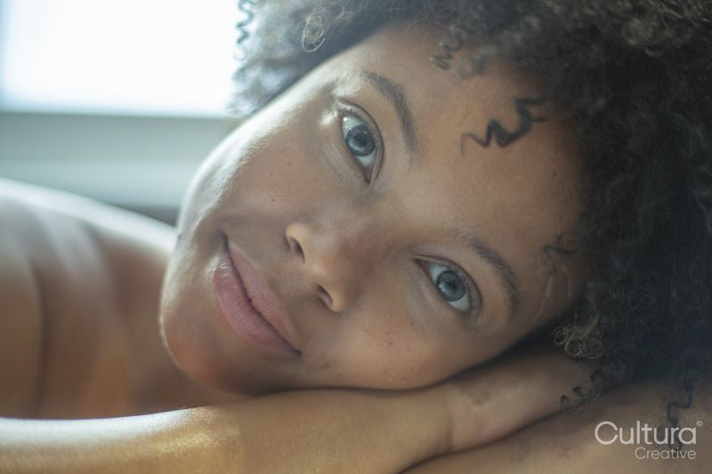 Close-up of woman leaning on edge of bathtub
