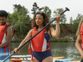 Friends warming up with oars before paddleboarding