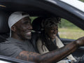 Smiling couple in car during road trip