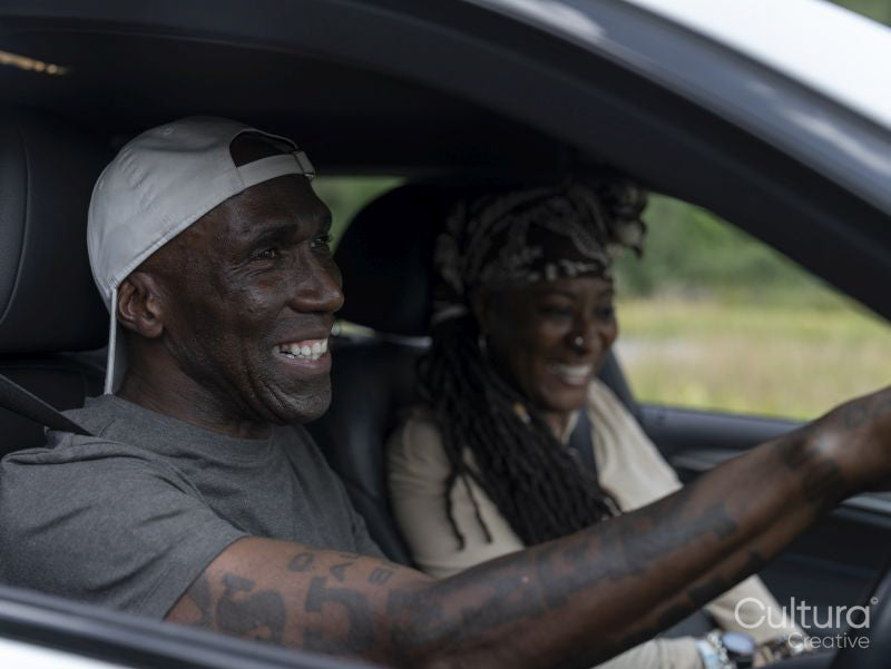 Smiling couple in car during road trip