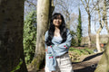 Smiling young woman standing in park