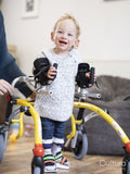 Boy with cerebral palsy using mobility walker and leg braces