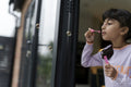 Little girls blowing soap bubbles outdoors