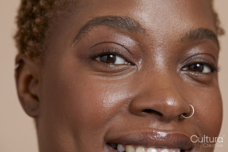 Close-up of smiling woman with nose ring