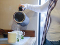 Woman pouring water into tea cup