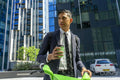 Businessman renting city bike in business district