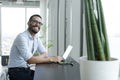 Businessman with laptop working in modern office