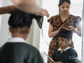 Mother wrapping traditional turban on son's head