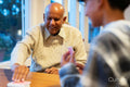 Senior man and grandson playing cards together