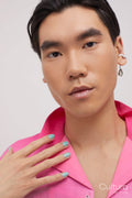 Studio portrait of handsome man with ear piercing